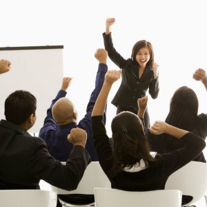 Woman speaker cheering on audience